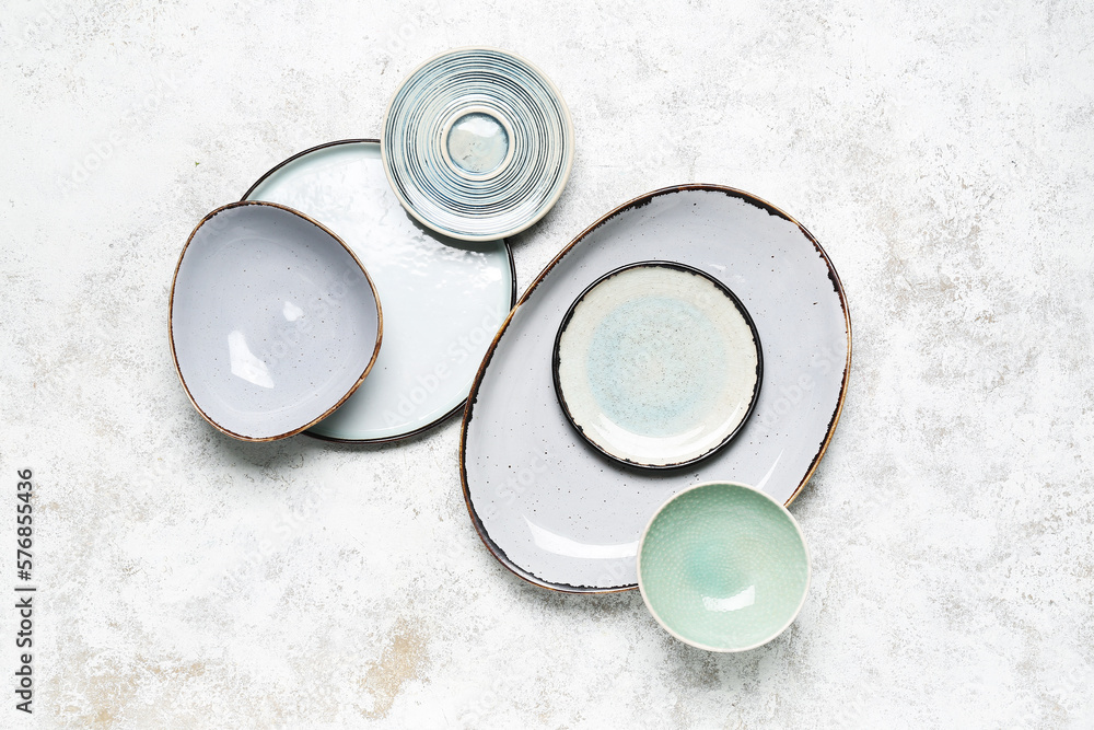 Composition with clean ceramic plates on white background