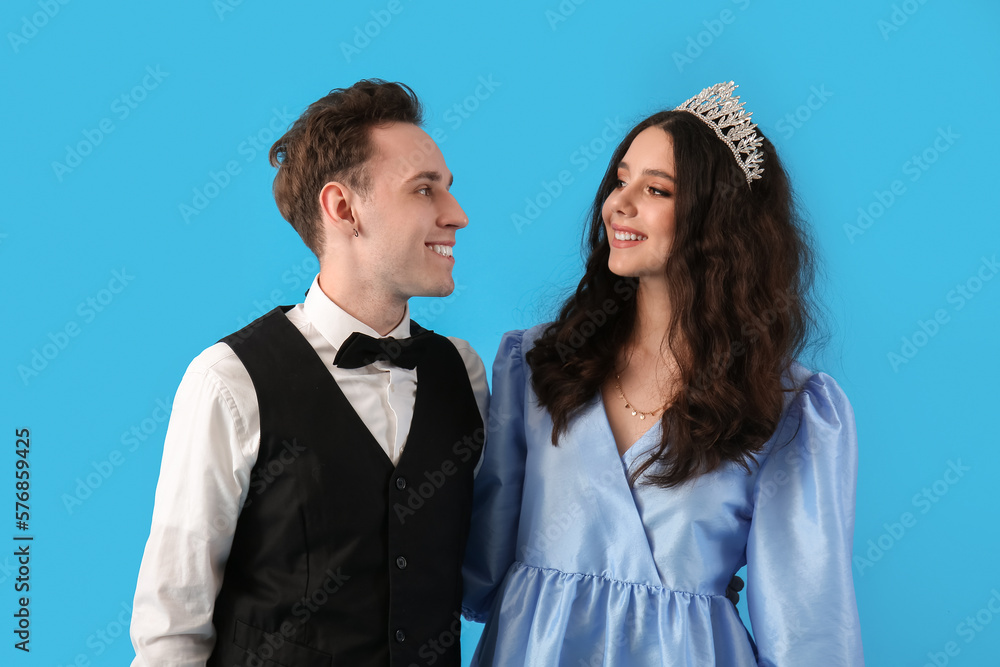 Beautiful couple dressed for prom on blue background