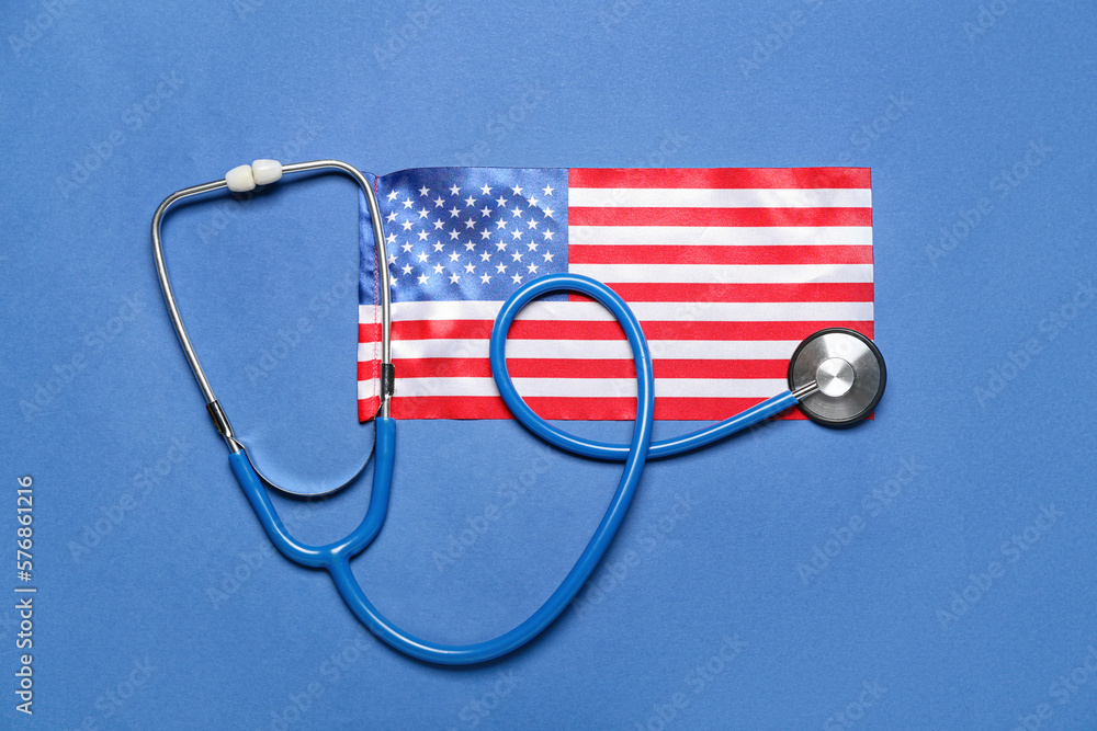 Stethoscope and USA flag on blue background