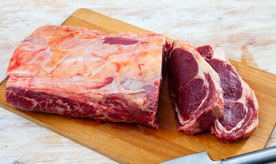 Poster - Raw beef tenderloin on wooden board closeup