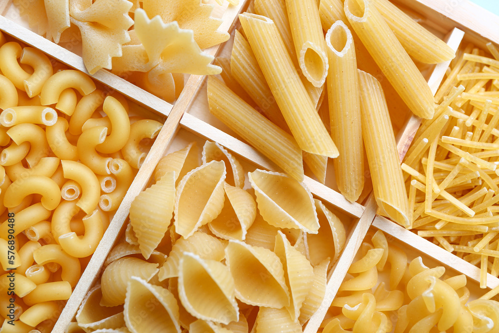 Box with different types of raw pasta, closeup