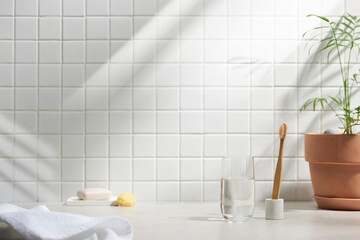 Wall Mural - Various objects on a white tile background with warm sunlight shining through
