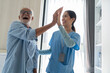 © Duangporn - Asian young nurse care caregiver help assistence high five retirement home nursing elderly health support.