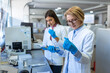 © Graphicroyalty - Modern Medical Research Laboratory: Female Scientist Working with Micro Pipette, Using Digital Tablet for Test Sample Analysis. Advanced Scientific Lab for Medicine, Biotechnology Development.