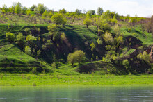 View Of The Dniester River In Spring. The River Surrounds The Mountain Slopes Covered With Lush, Bright Green Vegetation