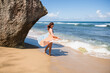 © Cavan Images - Solo Woman in a bikini with towel at the beach in Puerto Rico