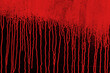 Red paint running down the black wall