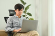 © Prathankarnpap - Successful young businessman using laptop, working on marketing project at modern office interior