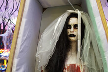 A Scary Mannequin Doll In A Bride's Outfit Is Lying In A Coffin. Halloween. High Quality Photo