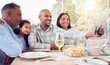 © Jesse Bettencourt/peopleimages.com - Black family selfie, lunch and happy in home with men, women and girl at table for celebration on web app. Man, digital photography app or profile picture for social media with kid, parents and woman