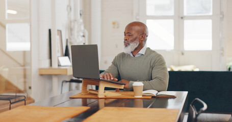 Laptop typing, black man and remote work in living room, lounge and work from home office for planning, internet research or technology. Mature freelancer, computer and thinking while reading email