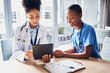 © Sharne T/peopleimages.com - Tablet, black woman or doctors with medical research reading news or tests results in hospital together. Teamwork, digital tech or African nurses planning or speaking of healthcare report on website