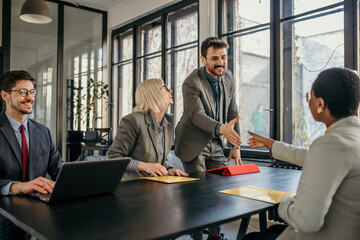 Wall Mural - Female candidate talking to human resource team while on a job interview in the office. Businesswoman handshake and business people. Successful business concept.