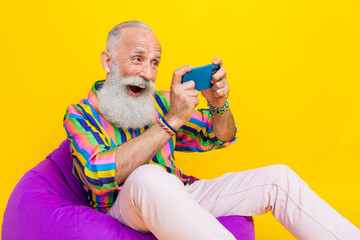 Sticker - Photo of impressed funky guy dressed striped shirt watching funny film modern device empty space isolated yellow color background