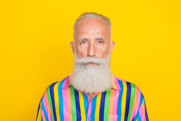 Poster - Photo of serious charming man wear colorful striped shirt looking you isolated yellow color background