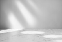 Empty Marble Table Top With Shadow Drop On White Wall Background