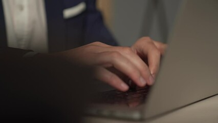 a man writes, works at a laptop in the office