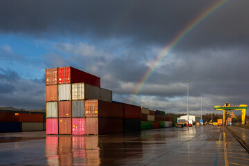 A stack of shipping containers on a deserted dock