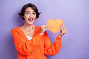 Poster - Photo of cheerful pretty cute lady wear comfort bright clothes showing paper card postcard empty space isolated on purple color background