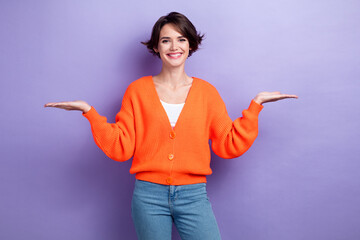 Photo of positive lady wear trendy bright clothes demonstrate empty space isolated on purple color background