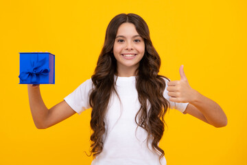 Poster - Portrait of teenager child girl 12, 13, 14, years old holding Christmas gift box. Teen giving birthday gift.