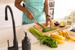 © Wavebreak Media - Midsection of mid adult african american woman chopping vegetables in kitchen at home