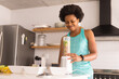 © Wavebreak Media - Smiling mid adult african american woman preparing healthy breakfast in kitchen at home