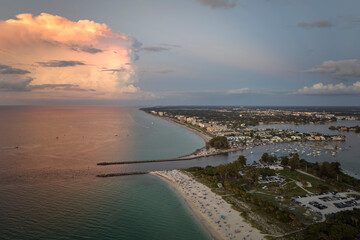 Canvas Print - Nokomis beach with soft white sand and North and South Jetty in Sarasota county, USA. Many people enjoing vacation time bathing in warm gulf water and tanning under hot Florida sun at sunset