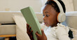 © Kirsten D/peopleimages.com - Language learning, headphones and black child with tablet for online education translation website or video call. Relax kid with digital technology listening and speaking for online learning games