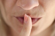 Woman showing shh gesture or to keep silent symbol