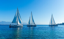 Boats And Yachts At The Sailing Regatta On Open Water. Sailing On The Wind Waves In The Sea.