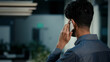 © Yuliia - Back rear view man talking phone indoors unknown adult Indian businessman employer office worker answer mobile call chatting by smartphone online conversation business communication distant cell talk