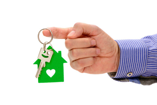 Fototapete - isolated house key holding in hand