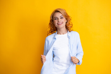 Happy smiling woman portrait. Attractive young pretty cheerful girl in casual clothing feeling happy and carefree, isolated yellow background. Happiness woman face.