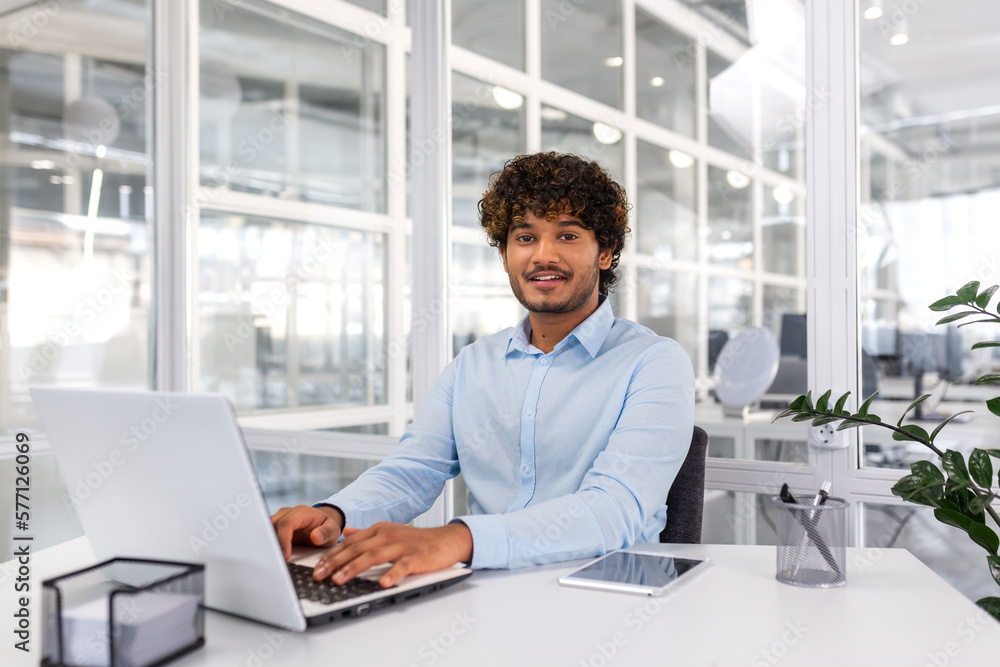 Portrait of young programmer inside office with laptop, indian man ...