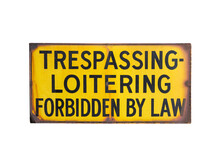 Rusty Old Trespassing And Loitering Forbidden By Law Sign.  Isolated With Cut Out Background.