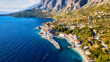 Croatia's Harbor Is A Sight To Behold From Above. This Breathtaking Aerial View Captures The Colorful Landscape Filled With Sailboats, Motorboats, And Luxurious Yachts Resting In A Clear Blue Bay. Add