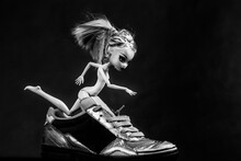 A Gothic Doll With Yellow Long Hair Running In Sneakers