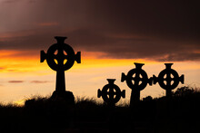 Silhouettes Of Gravestones With Celtic Crosses At Cross Abbey Graveyard At Dusk, Mullet Peninsula, County Mayo, Ireland