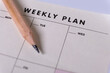 © Ensar - Weekly planner and wooden pencil. Calendar reminder, organizer, schedule, planning concept. Close-up of weekly plan paper