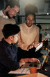 © A.B./peopleimages.com - Dark business, people and teamwork on tablet for planning, research and collaboration in night office. Diversity workers, digital technology and overtime online in agency, group strategy and web app