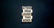 Actions speak louder words symbol. Concept words Actions speak louder than words on wooden blocks. Beautiful black table black background. Business new mindset for results concept. Copy space.