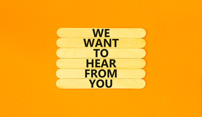 Wall Mural - Support symbol. Concept words We want to hear from you on wooden stick. Beautiful orange table orange background. Business support we want to hear from you concept. Copy space.