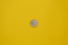 One Euro Coin Isolated On A Yellow Background. Fiat Currency Concept Minimal Flat Lay, Copy Space
