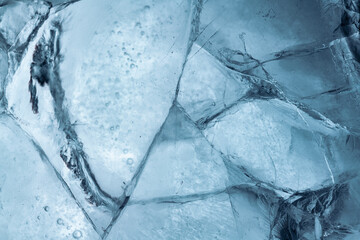 Wall Mural - Abstract ice background. Blue background with cracks on the ice surface