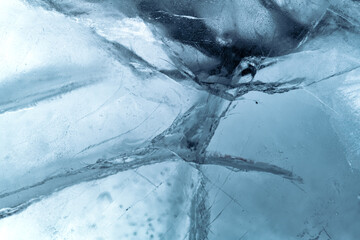 Wall Mural - Abstract ice background. Blue background with cracks on the ice surface