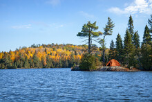 Orange Tent On Rocky Shore Of An Island On A Northern Minnesota Trout Lake During Autumn