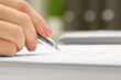 © New Africa - Woman signing document, closeup view. Space for text