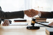 Lawyers shake hands with business people to seal a deal with partner lawyers. or a lawyer discussing contract agreements, handshake concepts, agreements, agreements
