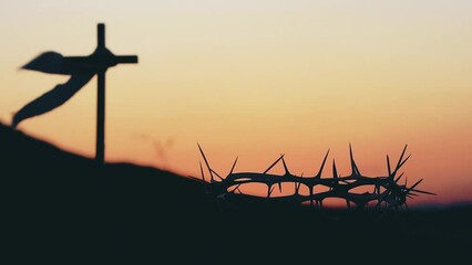 Wall Mural - The cross and crown of thorns symbolizing the sacrifice and suffering of Jesus Christ and the red sunset, Passion Week and Lent Easter concept
